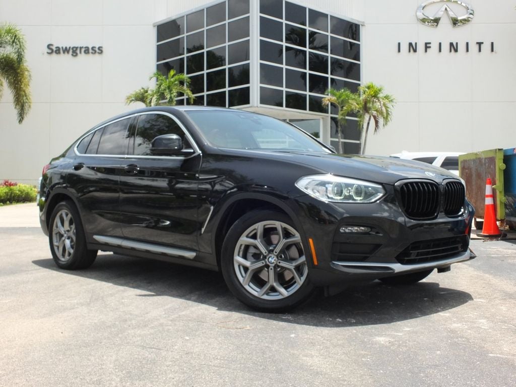 2021 BMW X4 xDrive30i in Black Sapphire Metallic — front three-quarter view