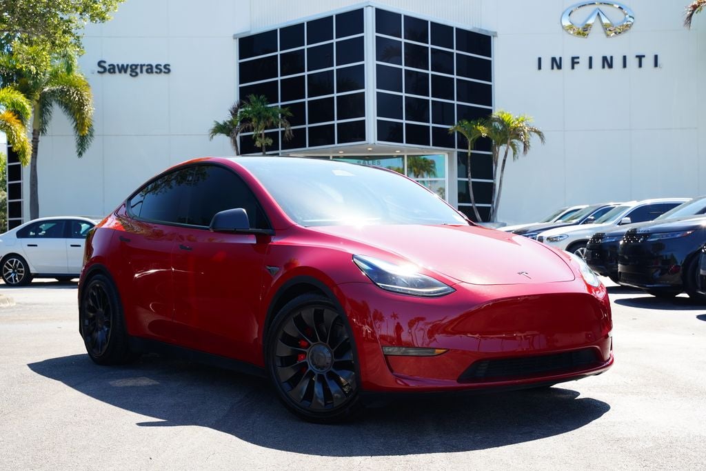 2022 Tesla Model Y Performance in Red Multi-Coat — front three-quarter view