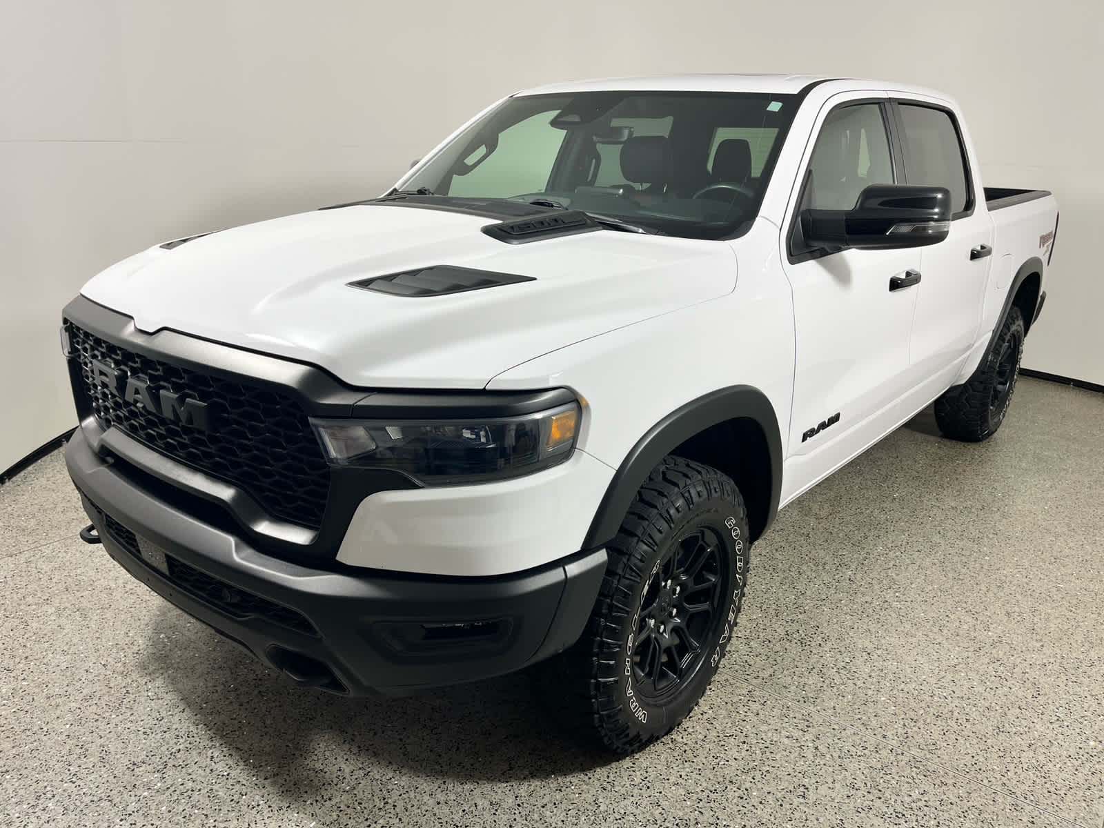 2025 RAM 1500 Rebel in Bright White Clearcoat — front three-quarter view
